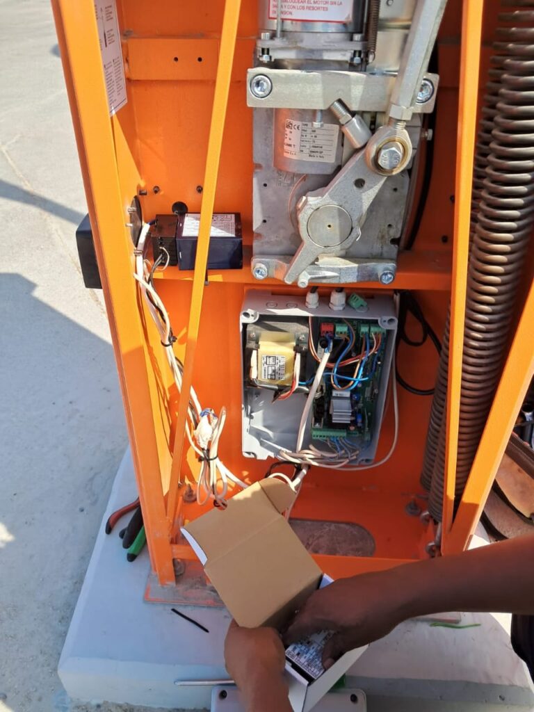 technician working on gate barrier loop detector  rectification  in dubai