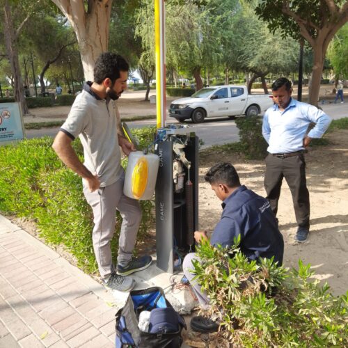 technician repairing barrier gate in dubai